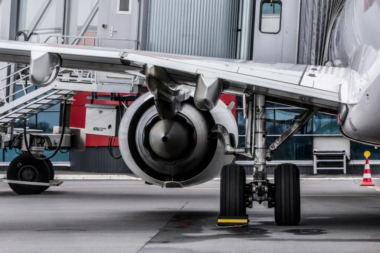 the nose of an airplane at an airport with stairs