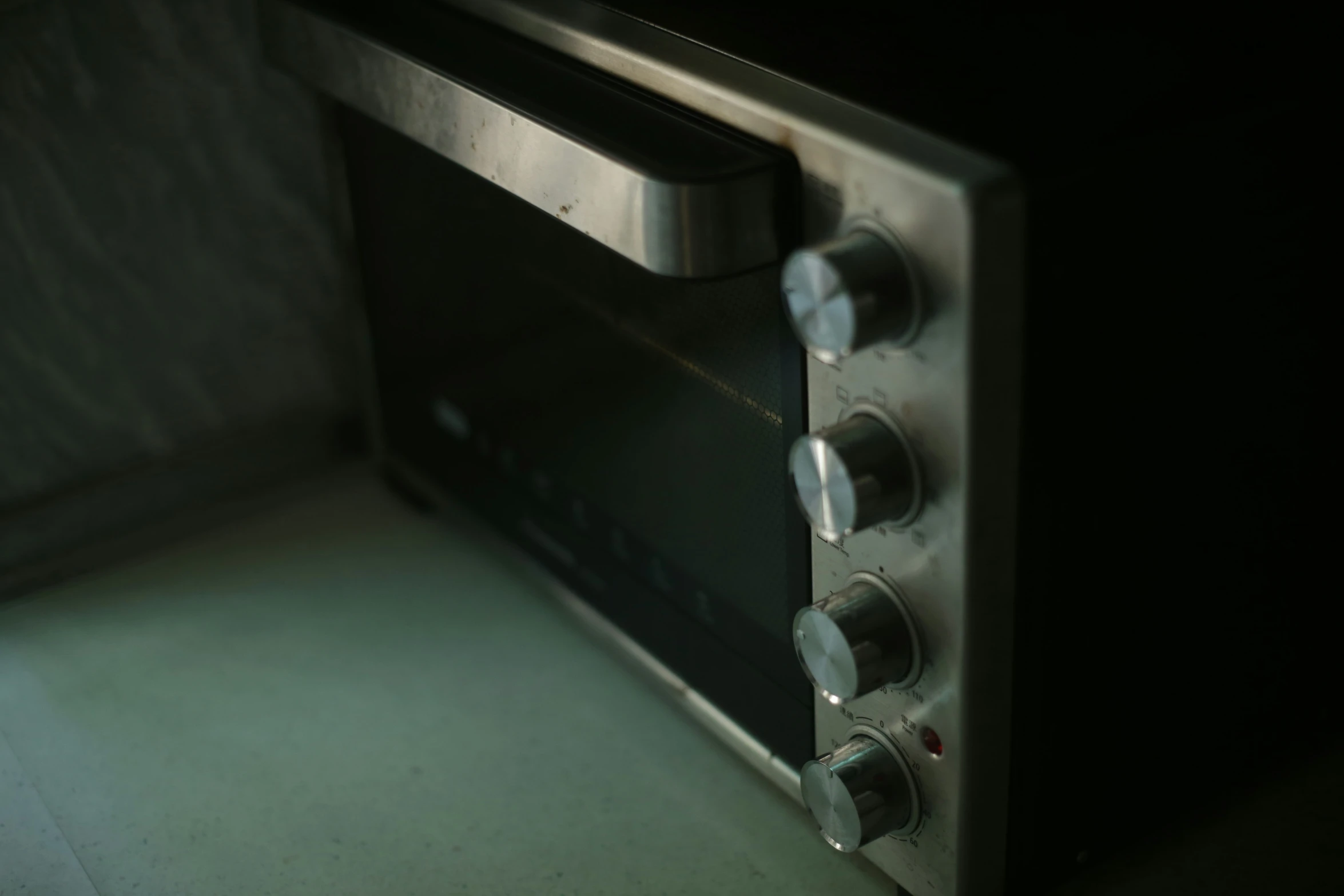 an oven door open with ons on it