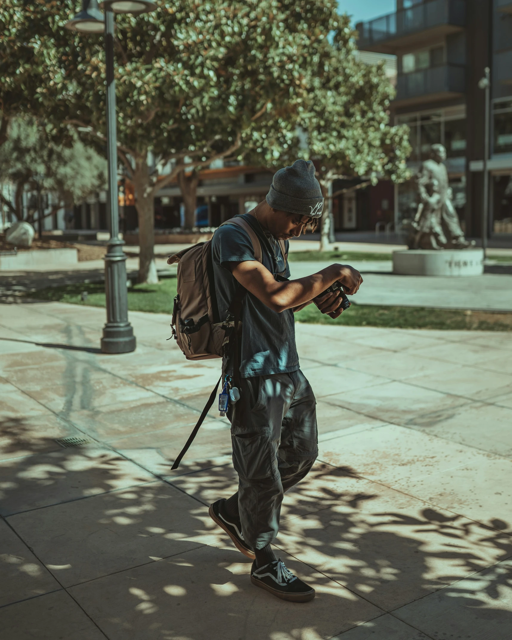 a man is looking at his cell phone while in the sun