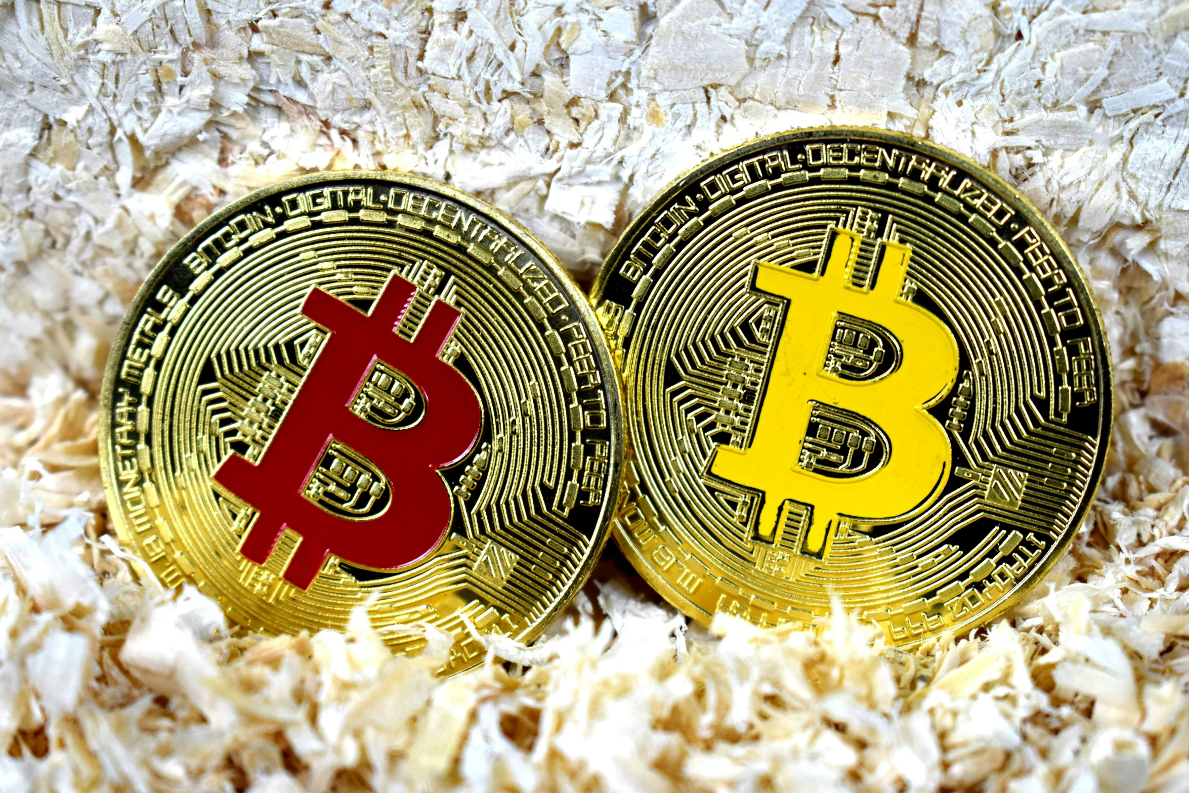 two bitcoins with the symbol bit right on them