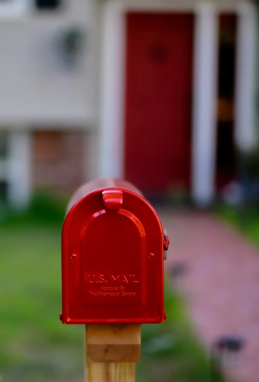a red mailbox in front of a house