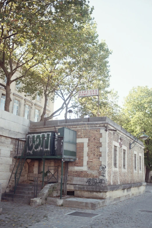 some graffiti is painted on the wall of an old brick building