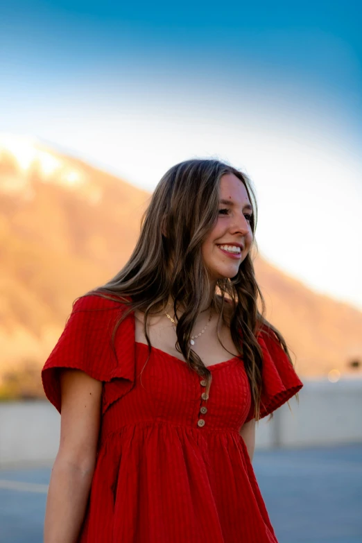 a woman smiles and looks away from the camera