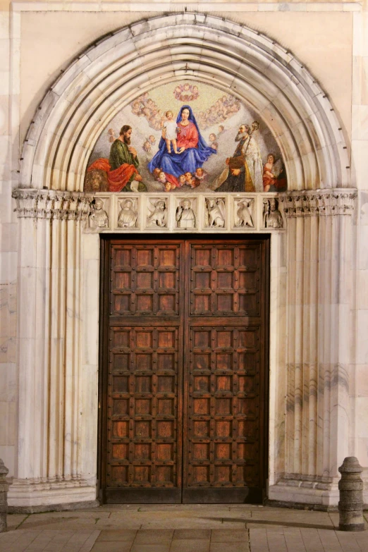 two large wood doors sit in front of an ornate entrance