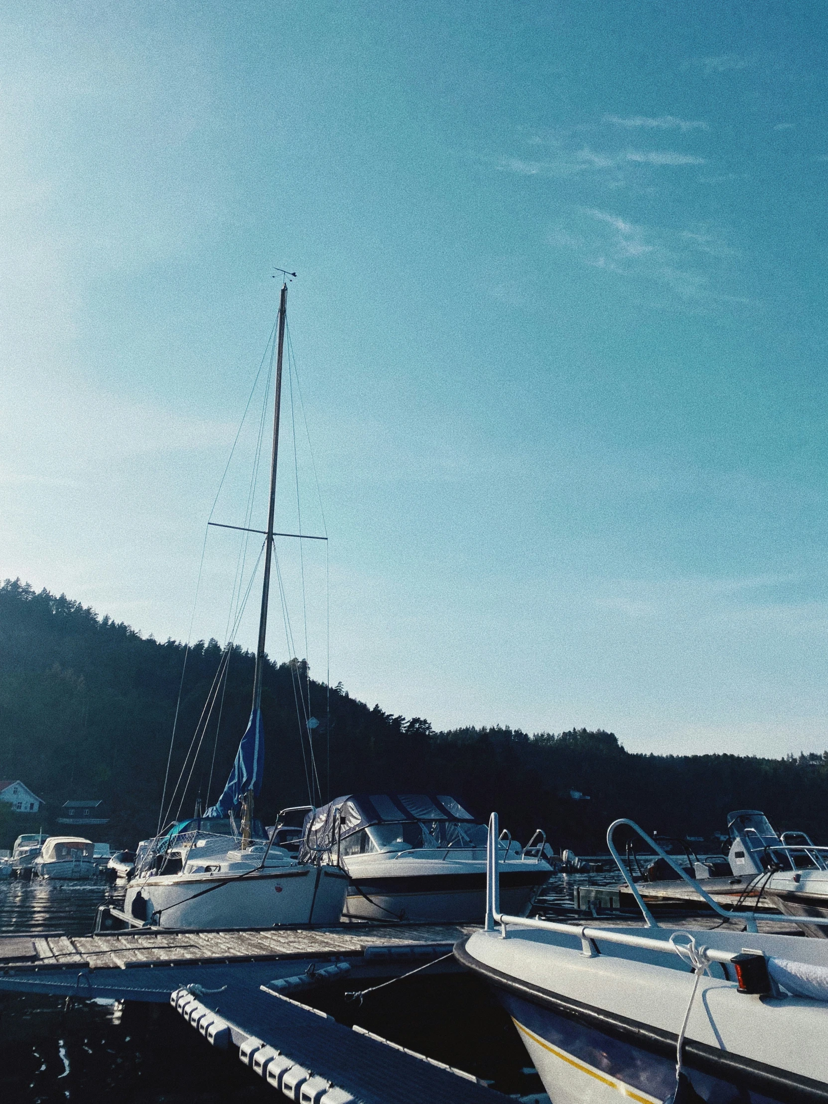 an old sailboat is docked on a sunny day