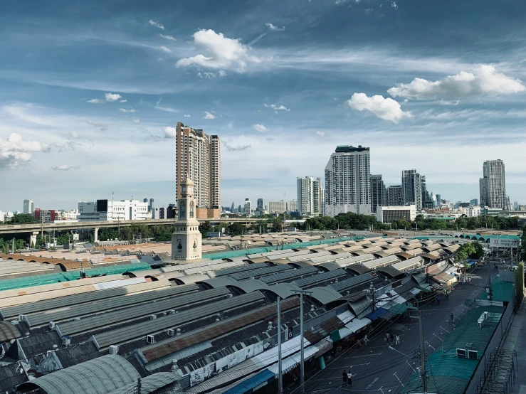 an aerial view of train station with large city buildings