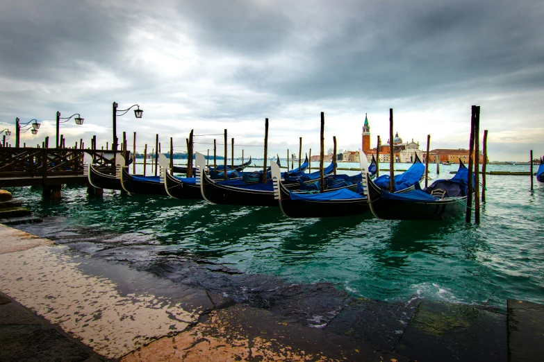 many blue boats are in a very deep harbor