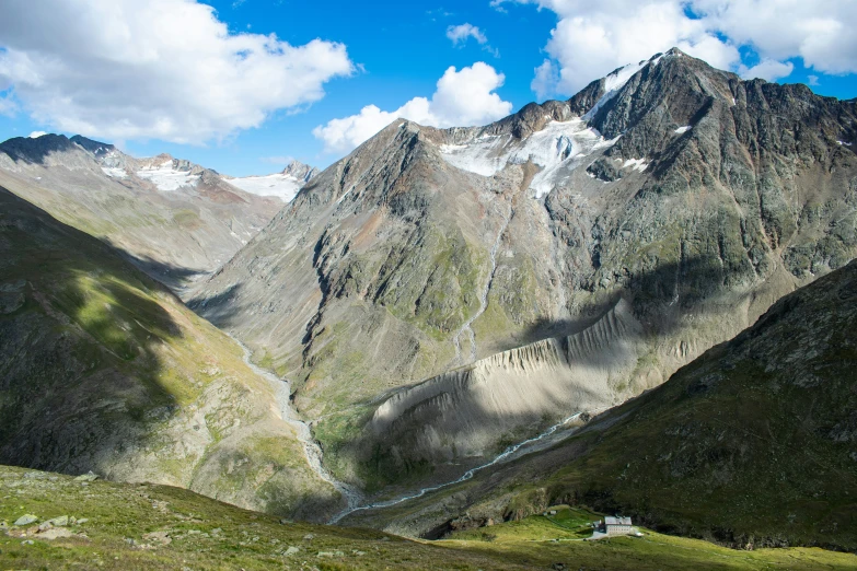 the valley below the mountain is filled with green vegetation