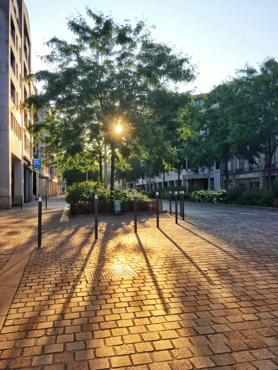 a light shines in between a street and a building