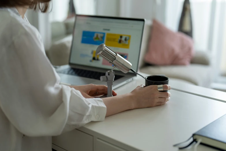 woman holding a coffee cup and a small scissor