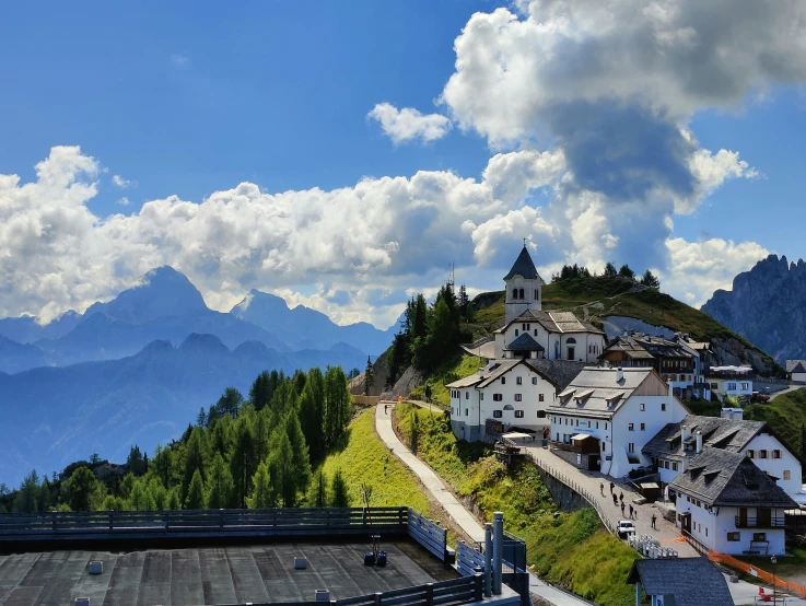 a small village on a hill in the middle of mountains