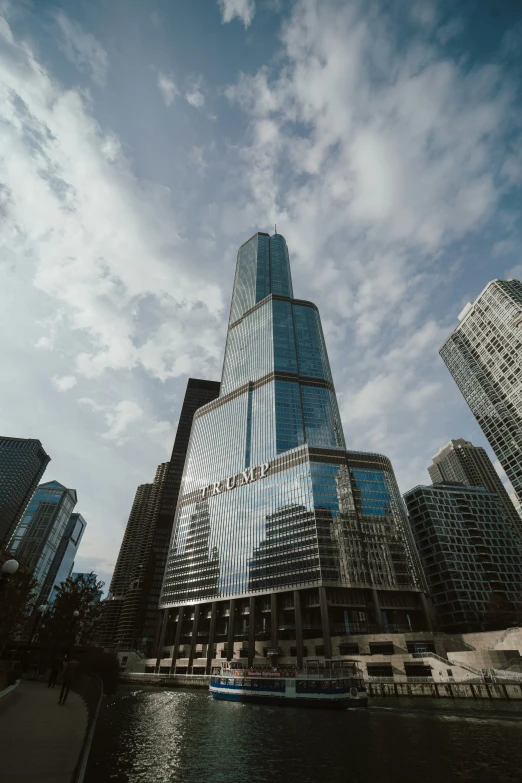 a very tall building near some water and buildings