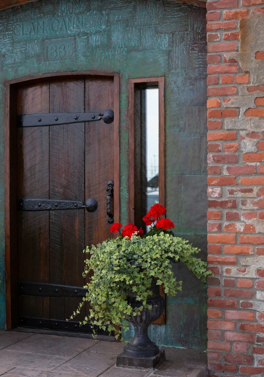 a house with two doors and a plant pot