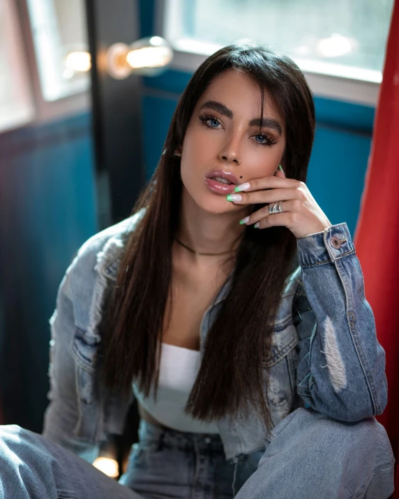 a woman sitting in a chair with her fingers on the lips