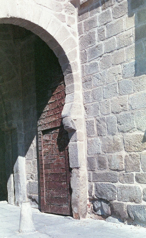 a stone wall and doorway is visible from the inside