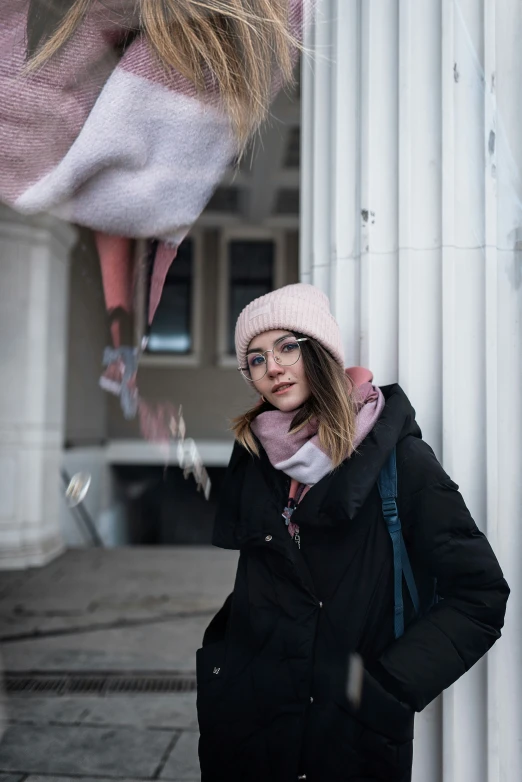 a woman is wearing winter clothing and a hat