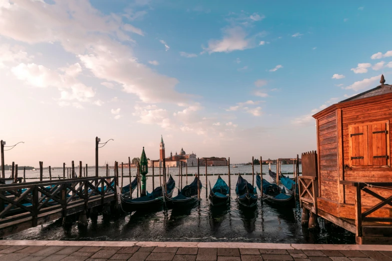 a pier in venice italy with gondola and boats tied to the post