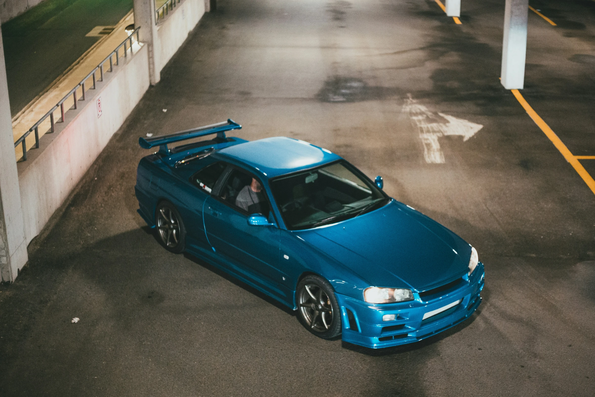 a blue sports car parked in the parking lot