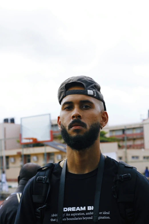 a man wearing a hat in front of the sky