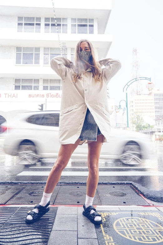 a woman poses in front of the city street