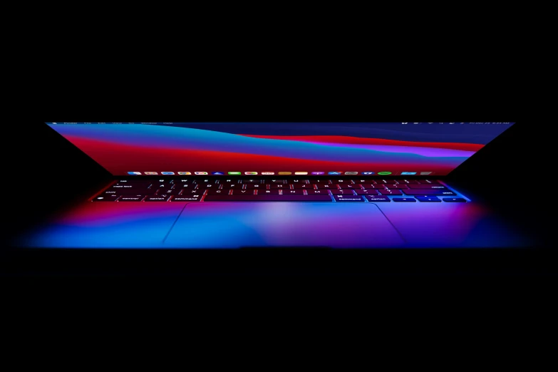 a laptop computer in the dark and lit up