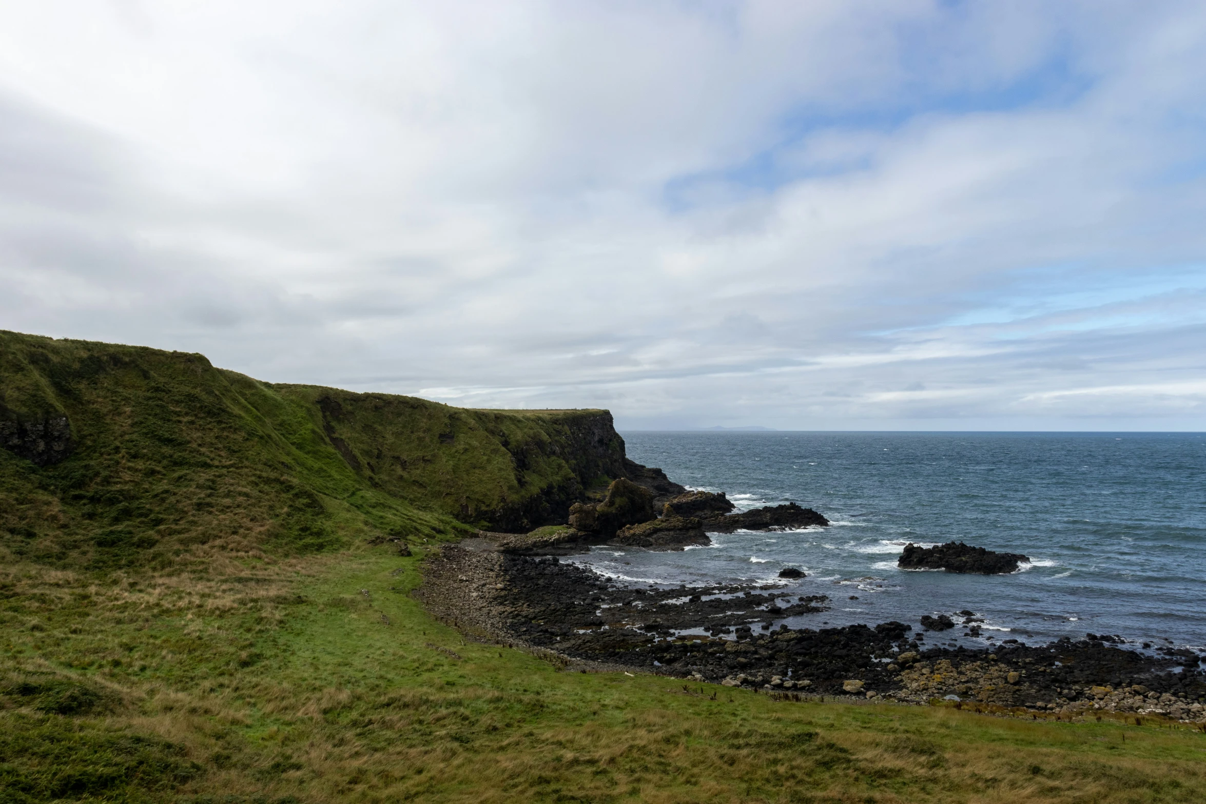 the ocean and cliffs are green in color