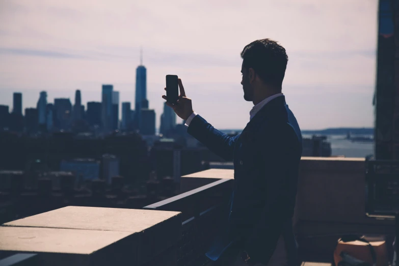 a person is taking a po with his cell phone in the city