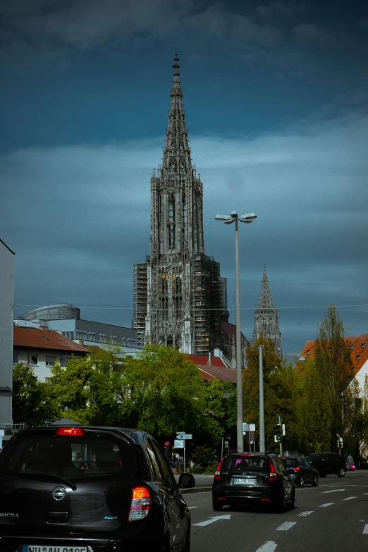 cars parked on a city street near a large building