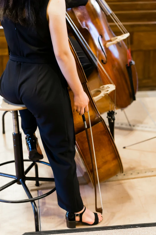 a girl playing the contrabas in a music band