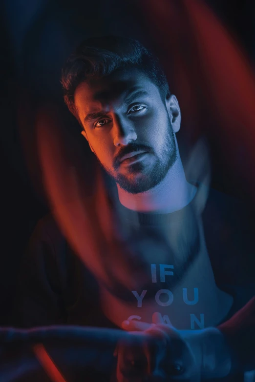 a man is shown in a shirt with red light coming out of his eyes