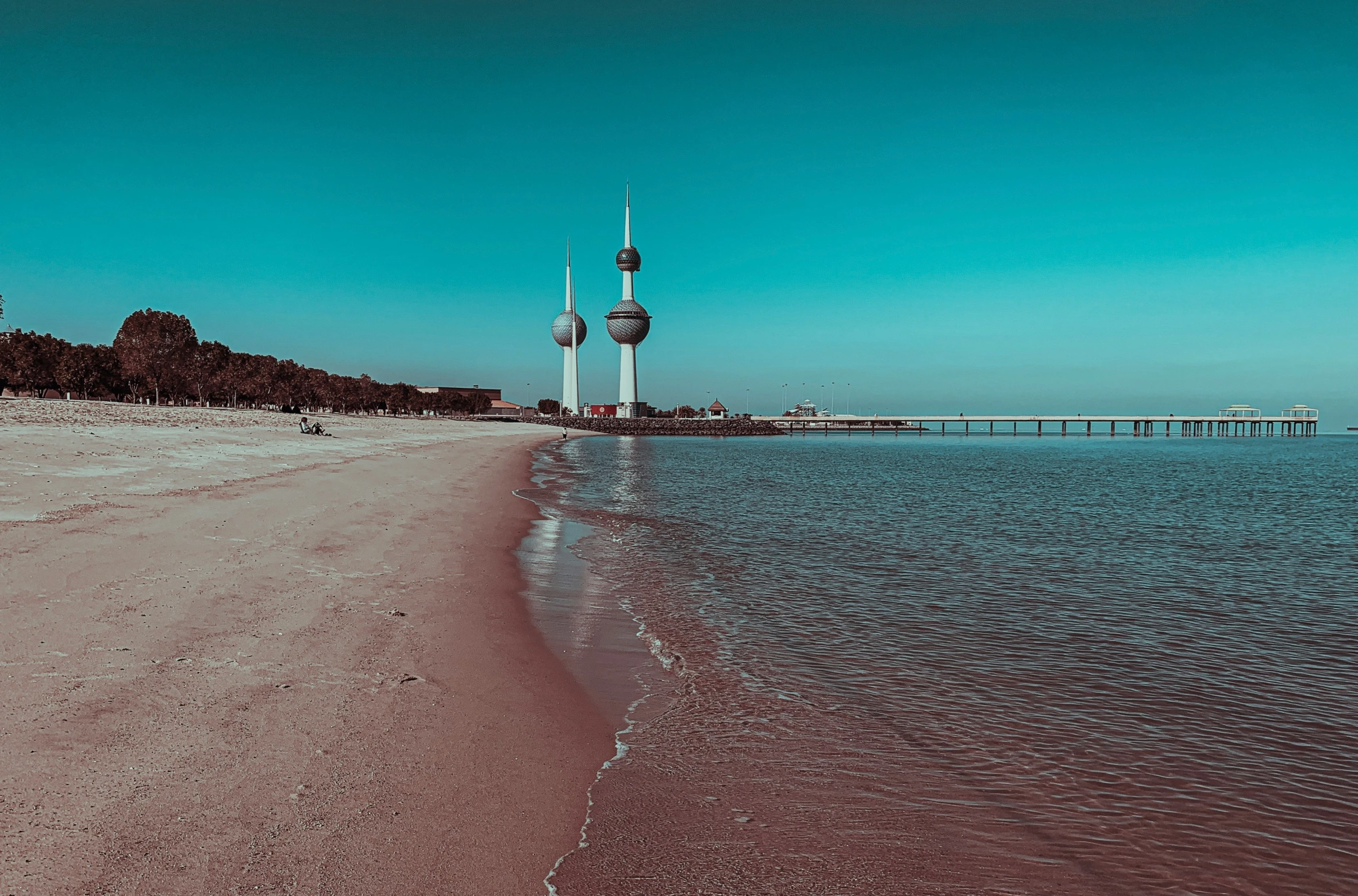 water and sand at the beach with the ocean in the background