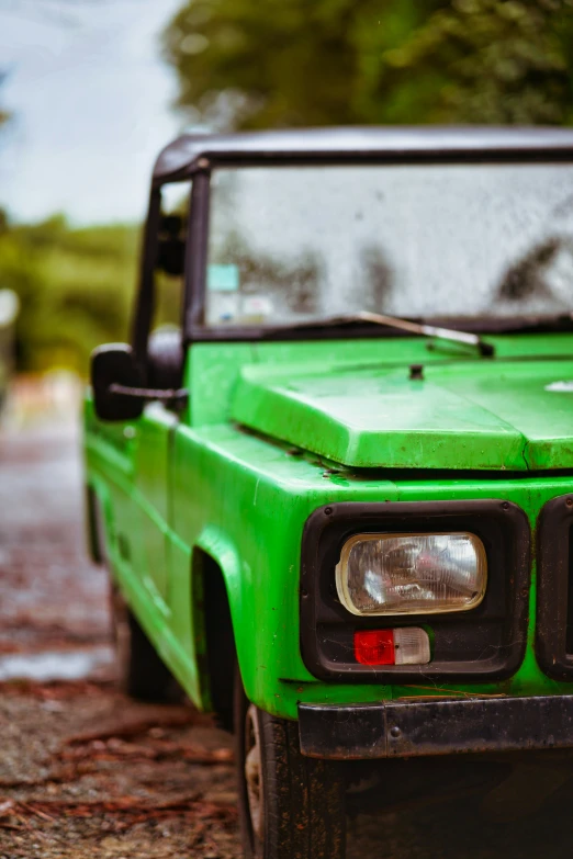 green truck with fog coming off its hood