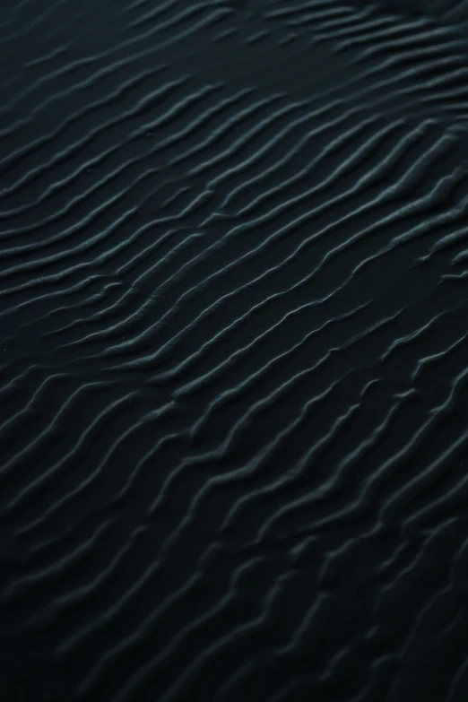 a close up of ripples in the water at night