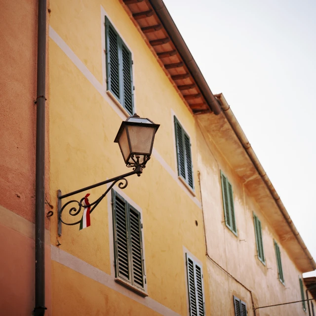 a light and two windows on the side of a building