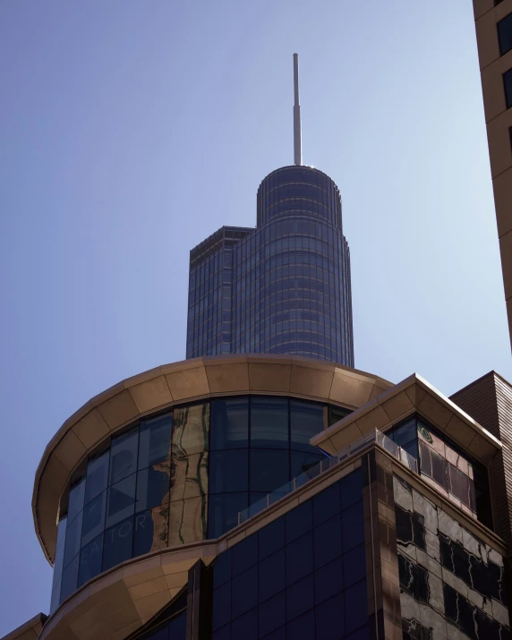 a tall skyscr towering above a city next to other tall buildings