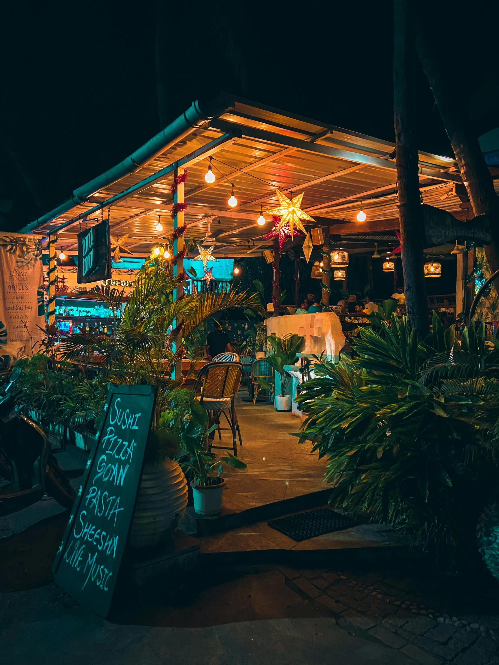 a lit patio at night in front of a restaurant