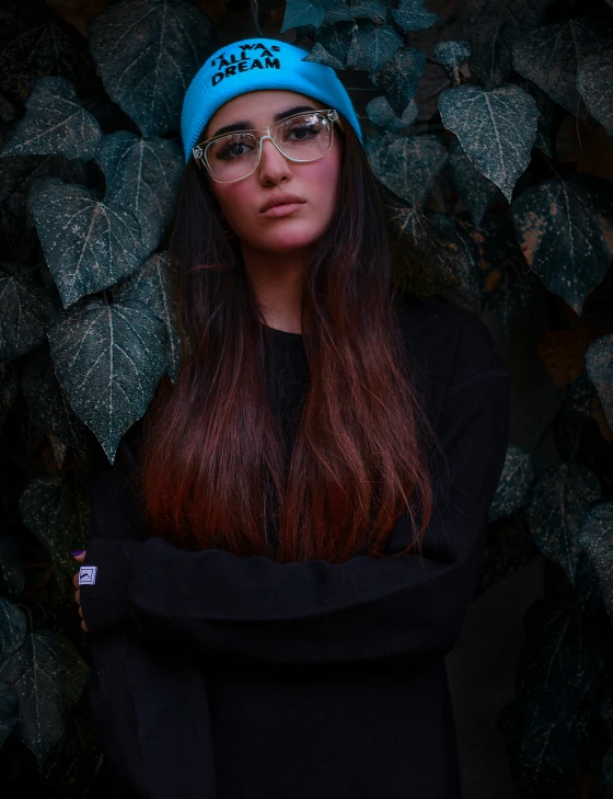 a woman wearing glasses with a blue cap