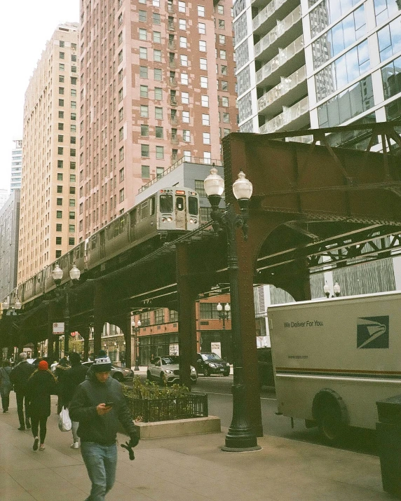 the commuter train passes by on a crowded street