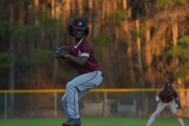 a baseball player standing on the mound throwing a ball