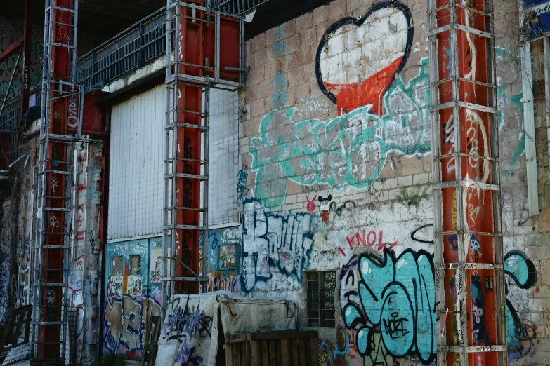 a graffiti covered building with scaffolding around it