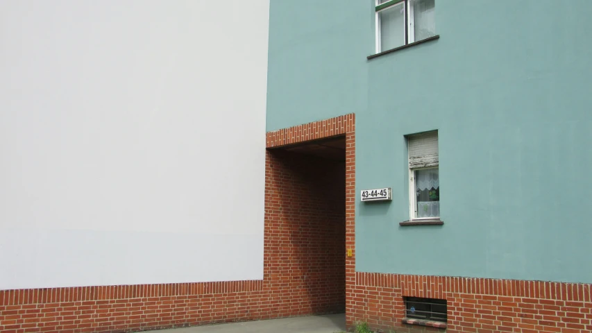 the blue building is on the corner near an open door