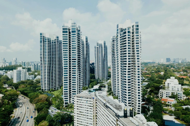 many tall buildings stand over a highway in the city