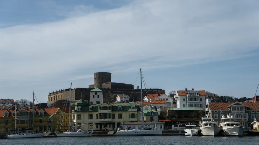 the boats are docked on the dock near the city