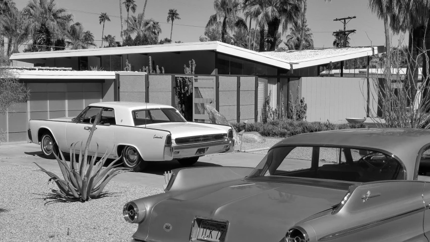 three cars parked in front of a building