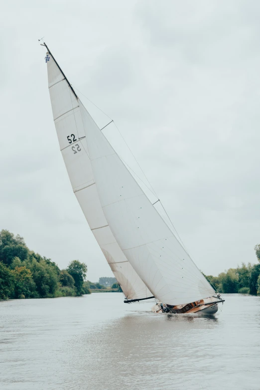 a large white boat sailing across a river