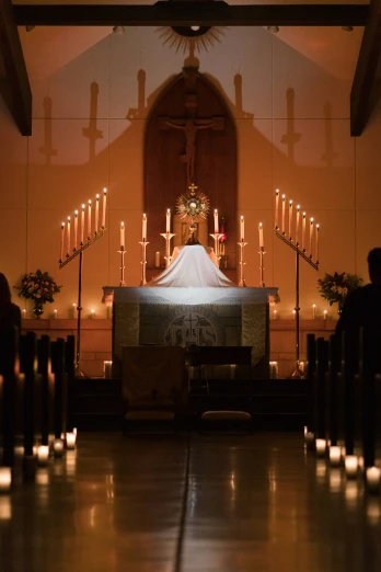 a church has candles lit in front of the alter
