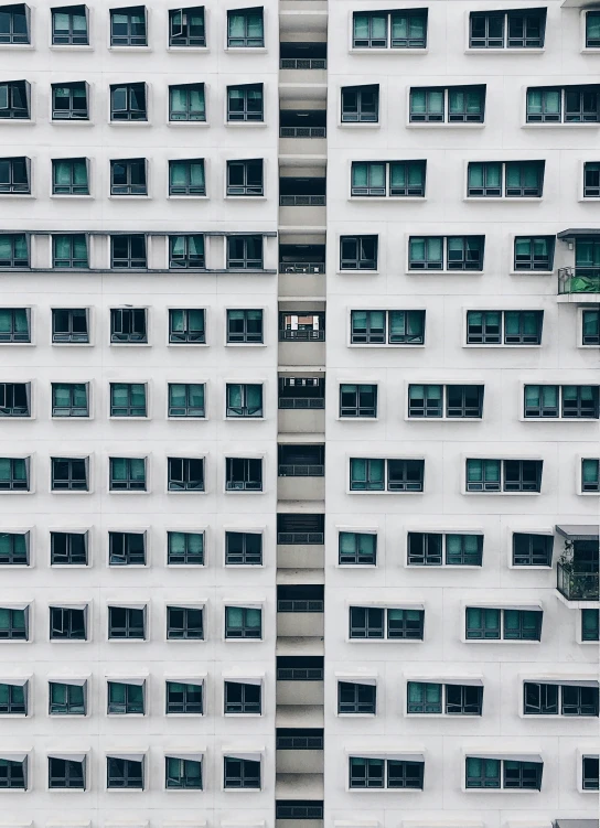 two white buildings with multiple windows that are all different