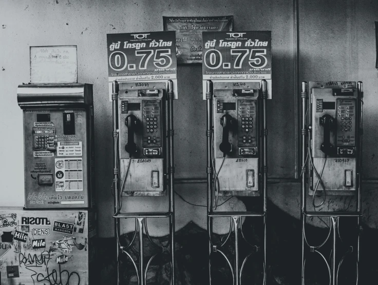 two telephones are standing on their stands near a wall