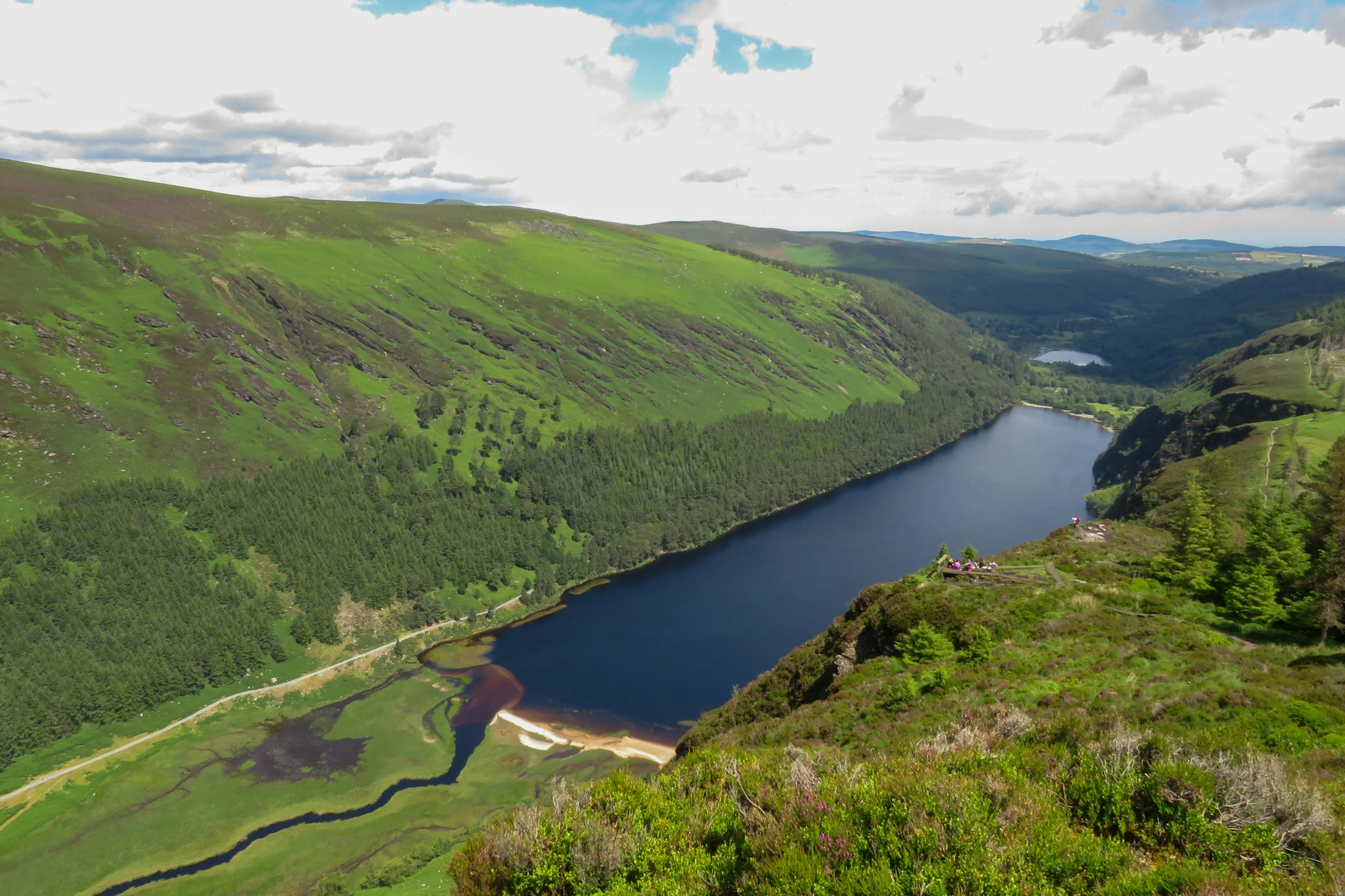 a big lake sits in the middle of a mountainous area