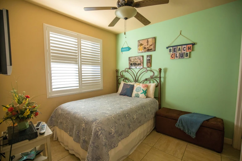 a view of the bedroom with a bed and ceiling fan